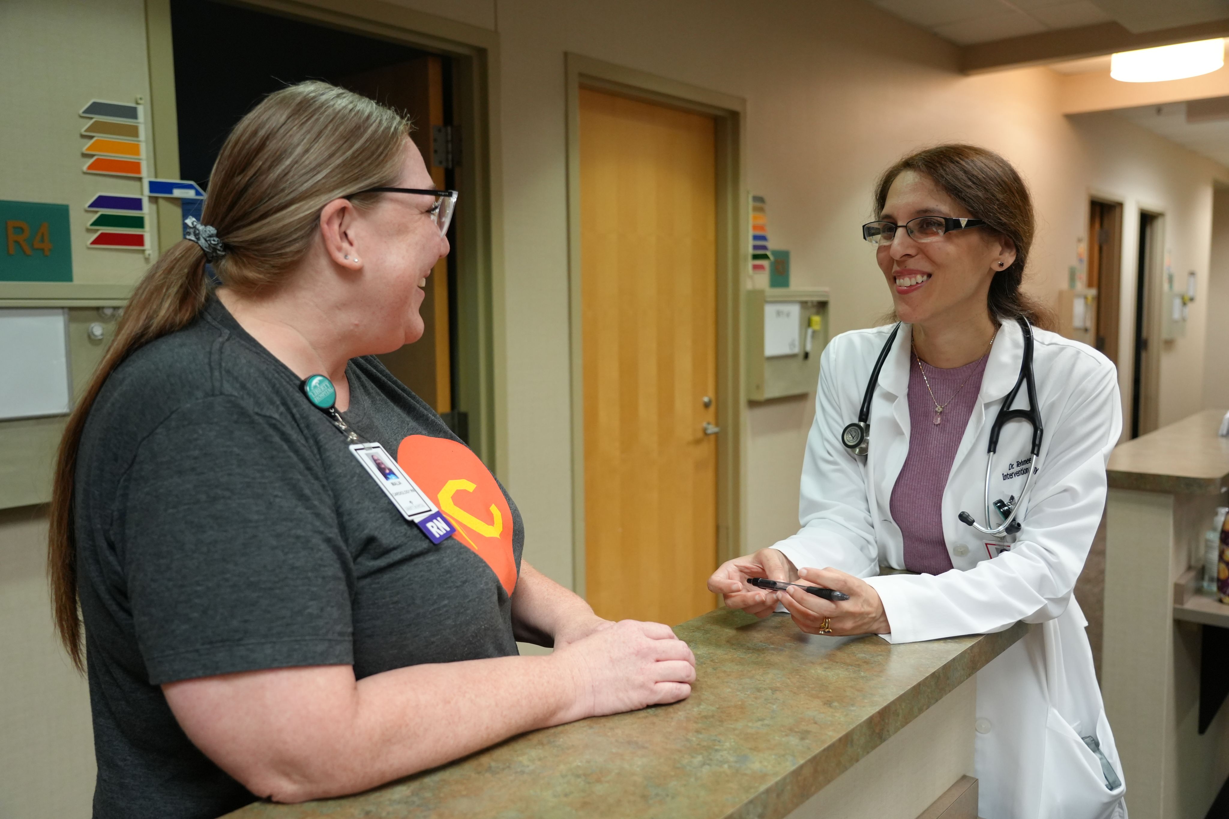doctor and staff member talking